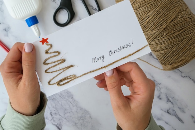 Hands holding embroidered card